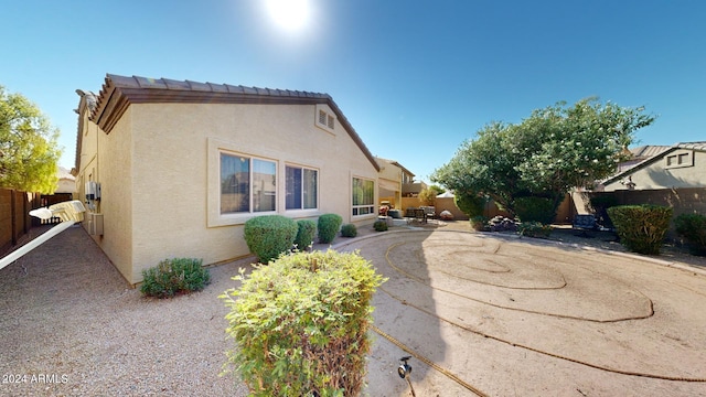 view of side of home featuring a patio