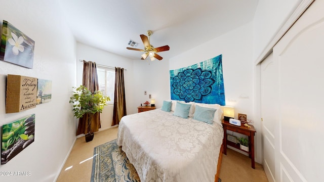 carpeted bedroom with ceiling fan and a closet