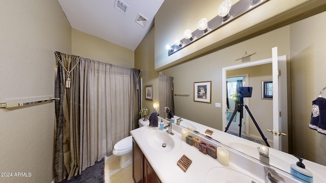 bathroom with vanity, lofted ceiling, tile patterned floors, and toilet