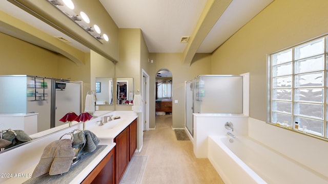 bathroom featuring beamed ceiling, vanity, and independent shower and bath