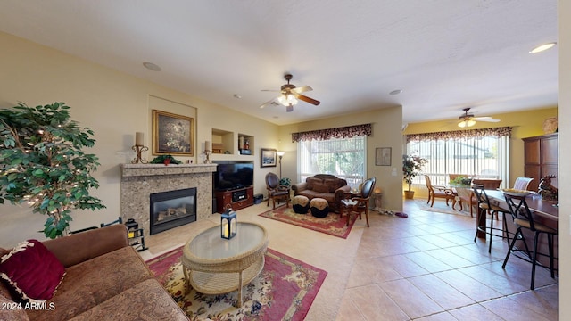 living room with light tile patterned floors, plenty of natural light, and ceiling fan