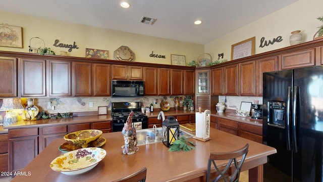 kitchen with tasteful backsplash and black appliances