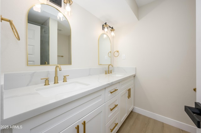 8341 E Keim Dr, Scottsdale, AZ 85250 - bathroom featuring double vanity and wood finished floors