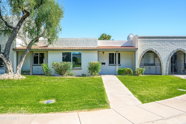 8341 E Keim Dr, Scottsdale, AZ 85250 - view of front of house featuring a front yard, stucco siding, and a tiled roof