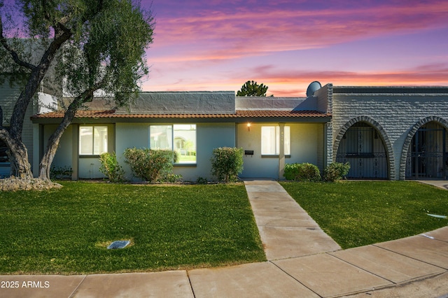 8341 E Keim Dr, Scottsdale, AZ 85250 - view of front of home with a lawn, stucco siding, and a tile roof