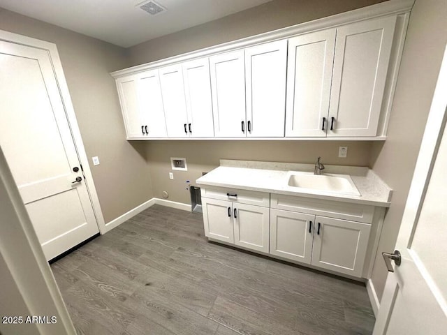 2734 N Trevino Pl, Mesa, AZ 85215 - washroom with washer hookup, light wood finished floors, cabinet space, visible vents, and a sink