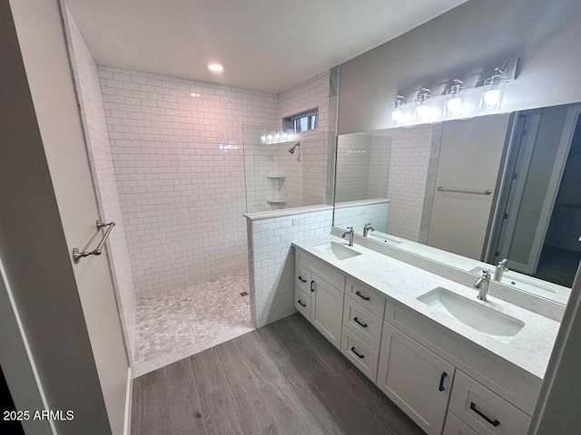 2734 N Trevino Pl, Mesa, AZ 85215 - bathroom featuring double vanity, a walk in shower, a sink, and wood finished floors