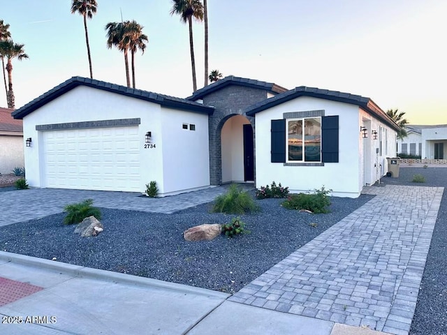 2734 N Trevino Pl, Mesa, AZ 85215 - ranch-style house featuring decorative driveway, an attached garage, and stucco siding