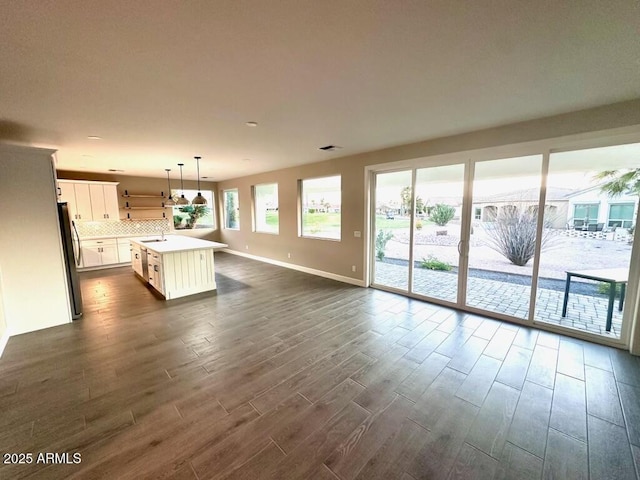 2734 N Trevino Pl, Mesa, AZ 85215 - kitchen featuring dark wood-style flooring, freestanding refrigerator, a sink, light countertops, and backsplash