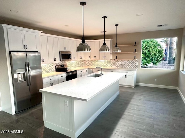 2734 N Trevino Pl, Mesa, AZ 85215 - kitchen featuring stainless steel appliances, white cabinets, a sink, and decorative backsplash