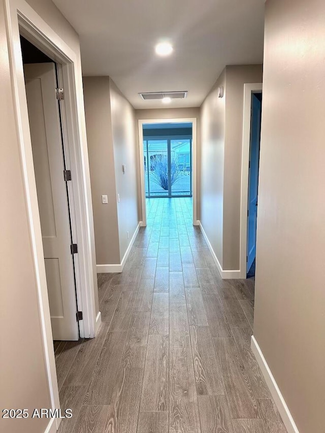 2734 N Trevino Pl, Mesa, AZ 85215 - hallway with visible vents, baseboards, and wood finished floors