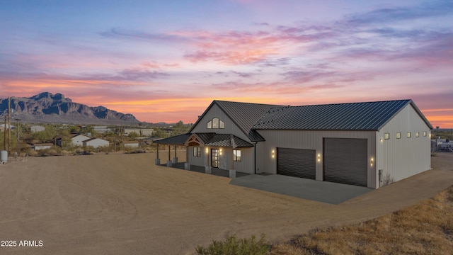 modern farmhouse style home featuring a mountain view, a porch, and a garage