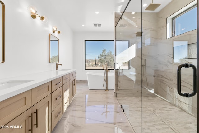 bathroom featuring vanity and separate shower and tub