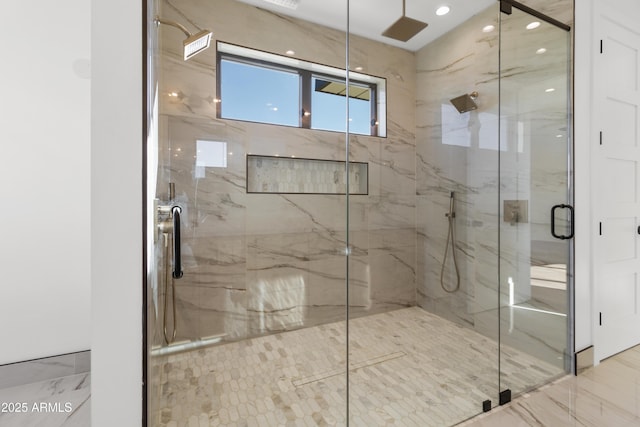 bathroom featuring a shower with door