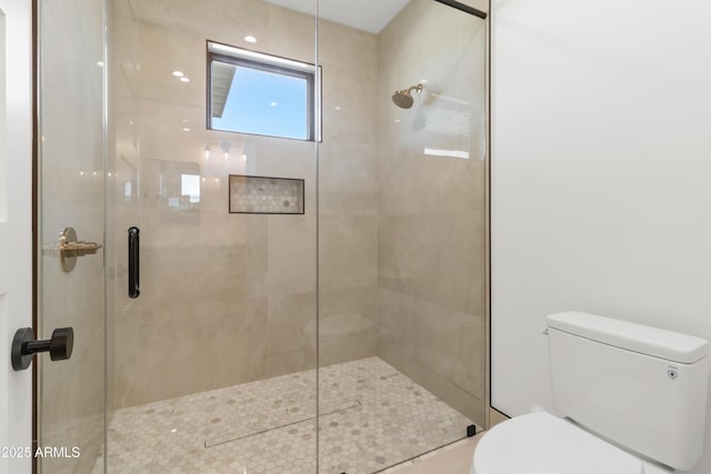 bathroom featuring toilet and walk in shower