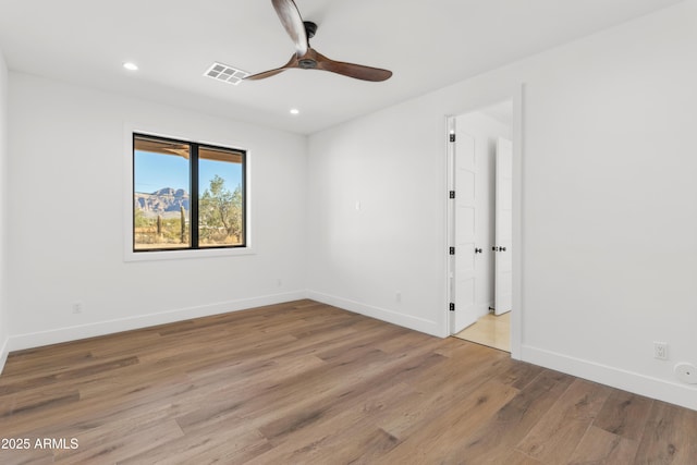 spare room featuring ceiling fan and light hardwood / wood-style floors