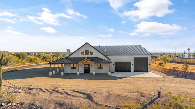 modern farmhouse style home with covered porch and a garage