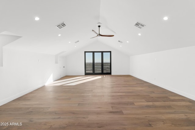 additional living space with ceiling fan, hardwood / wood-style floors, and vaulted ceiling