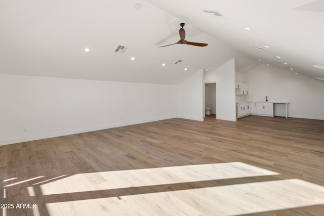 bonus room with vaulted ceiling, light hardwood / wood-style flooring, and ceiling fan