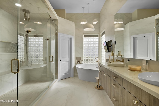 bathroom featuring tile patterned flooring, vanity, a high ceiling, and plus walk in shower