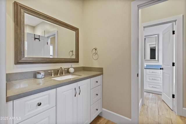 bathroom with hardwood / wood-style floors and vanity