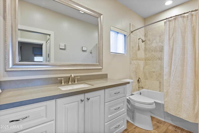 full bathroom with shower / bath combination with curtain, vanity, hardwood / wood-style flooring, and toilet