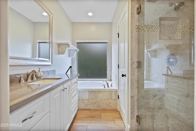 bathroom with vanity and independent shower and bath