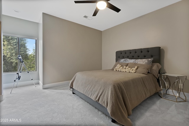 bedroom with ceiling fan and light carpet