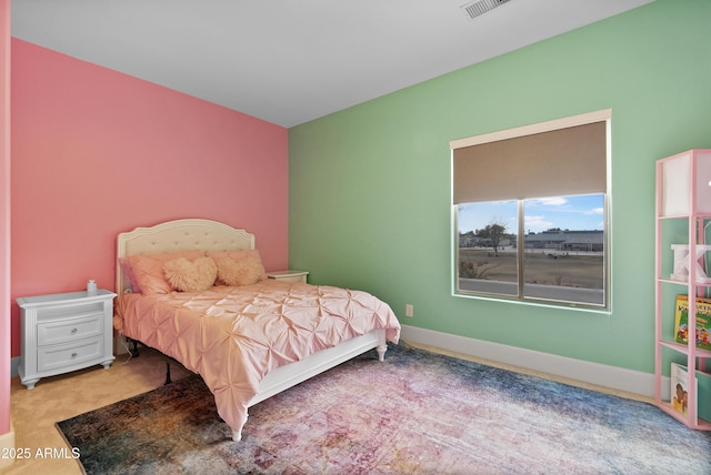 bedroom with light colored carpet