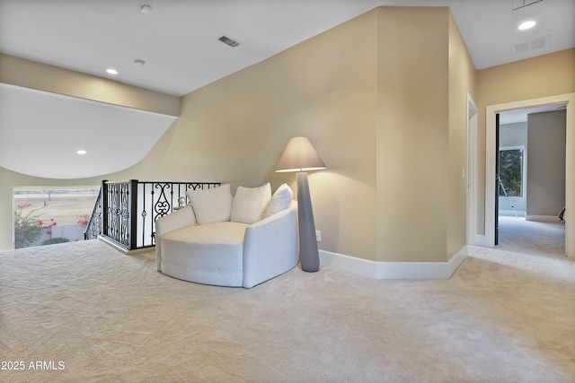 sitting room featuring light carpet