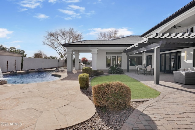 exterior space featuring pool water feature, a fenced in pool, and a pergola