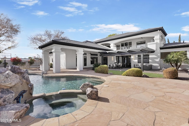 back of property featuring outdoor lounge area, ceiling fan, a swimming pool with hot tub, and a patio