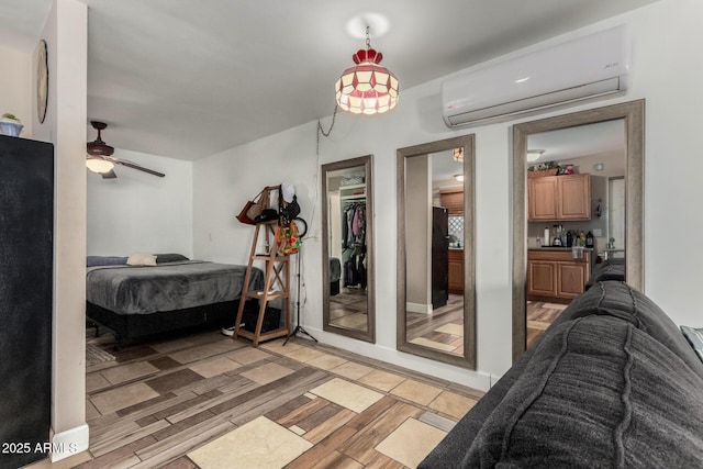 bedroom featuring light wood finished floors and a wall mounted AC