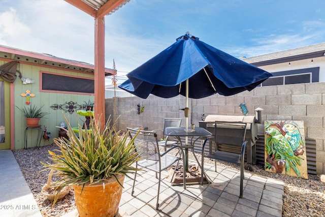 view of patio / terrace featuring fence