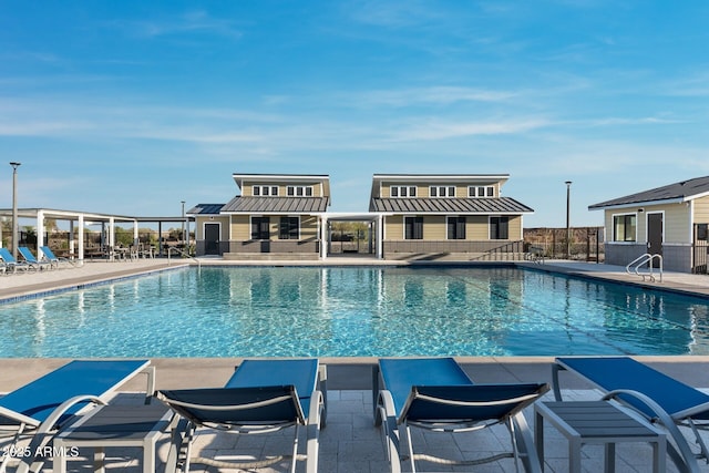 pool with a patio and fence