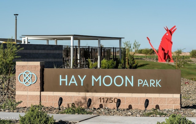 community / neighborhood sign with fence