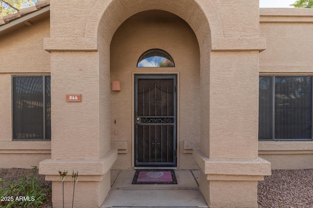 entrance to property with stucco siding