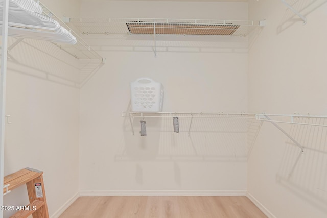 spacious closet with visible vents and wood finished floors