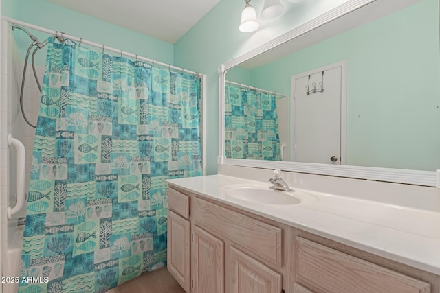 bathroom with curtained shower and vanity