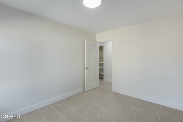 spare room with light tile patterned floors