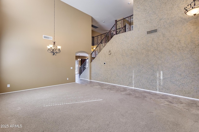 unfurnished living room with a high ceiling