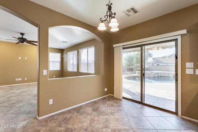 doorway to outside with ceiling fan with notable chandelier