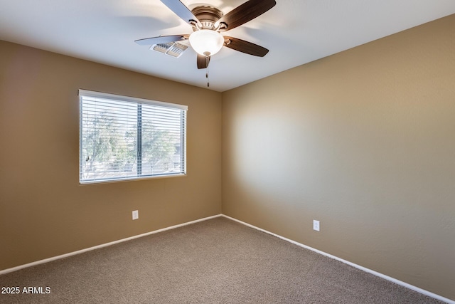 spare room featuring ceiling fan and carpet flooring