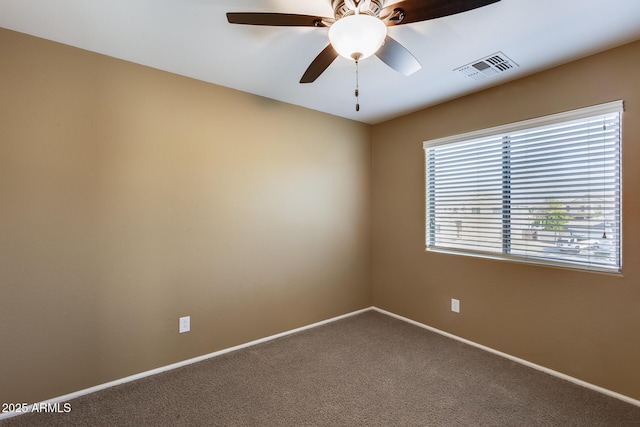 carpeted spare room featuring ceiling fan