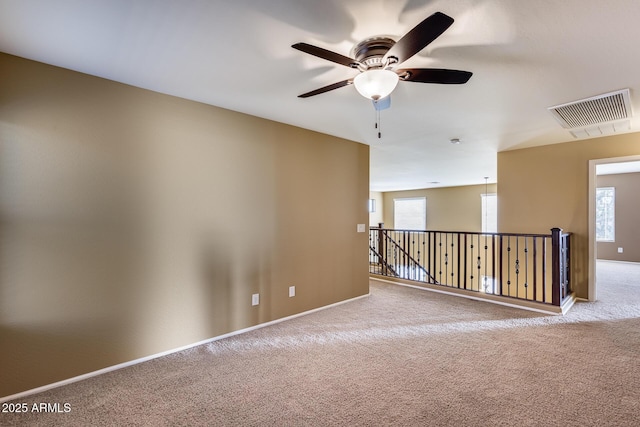 carpeted empty room with ceiling fan