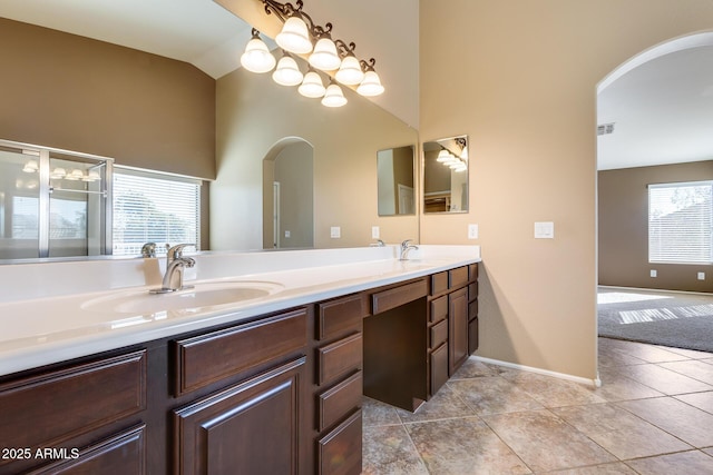 bathroom featuring vanity, lofted ceiling, and tile patterned flooring