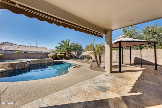 view of pool featuring a gazebo, a patio area, and an in ground hot tub