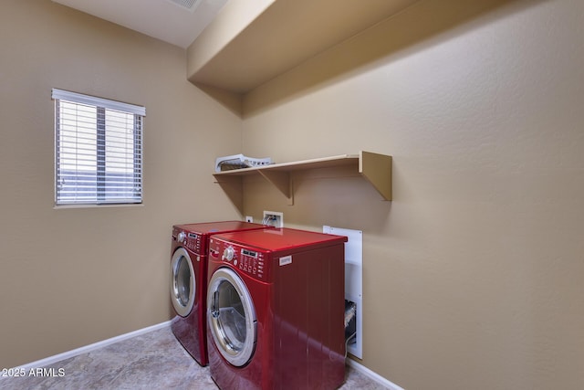 clothes washing area with light carpet and washer and clothes dryer