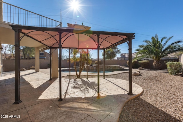 view of patio / terrace with a fenced in pool and a gazebo