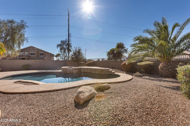 view of pool with an in ground hot tub